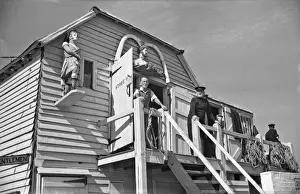 Convenience Prints: Men at coastal storage hut