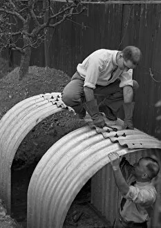 Nuts Gallery: Two men constructing an Anderson shelter