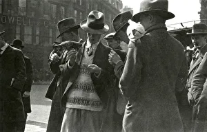Feed Gallery: Men feeding pigeons in a London street