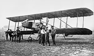 Men in a field with an early biplane