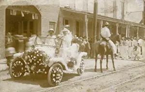 Leduc Prints: Men in flower-covered car in a parade, USA
