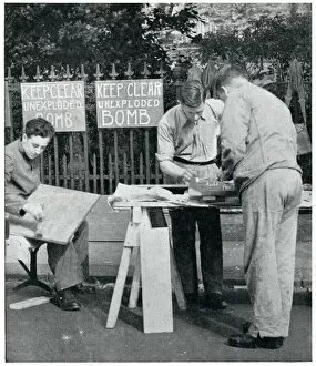 Volunteers Gallery: Men painting warning signs for unexploded bombs, Sept 1939
