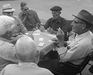 Age D Gallery: Six men playing cards at a table in the street
