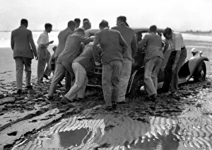 Push Prints: Men pushing car on wet beach