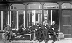 Five men relaxing on a bench