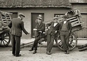 Men resting at the side of a cart