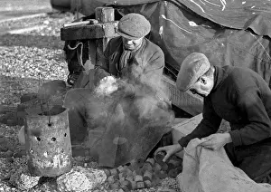 Mallet Prints: Two men sitting by a smoking brazier
