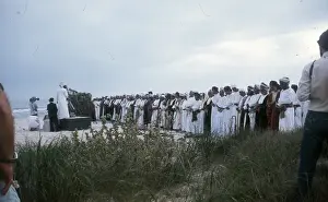 Salalah Prints: Men stand praying by the beach in Oman