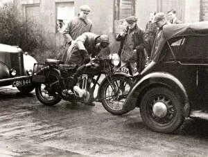 Gathering Collection: Men standing around an Ariel motorcycle