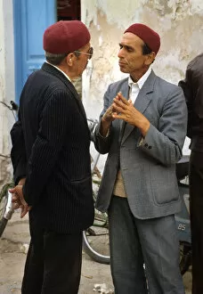 Images Dated 4th September 2019: Two men talk in the street in Houmt Souk, Djerba, Tunisia