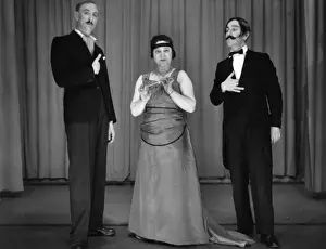Two men and a woman performing in a comic sketch