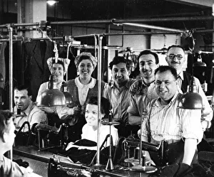 Men and women in a tailors workshop