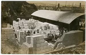 Men at work with paving stones and bricks near docks, UK