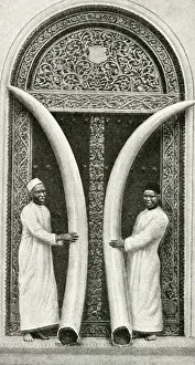 Zanzibar Prints: Men of Zanzibar holding large tusks, Tanzania, East Africa