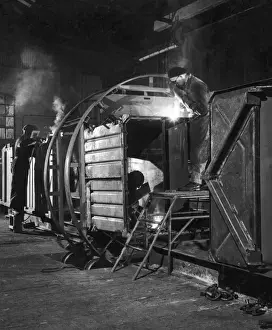 Weld Prints: Metalworkers welding a railway carriage