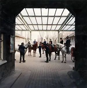 Metropolitan Police officers on horseback outside stable