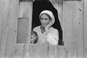 Corral Prints: Mexican woman and son looking out of window into corral, San