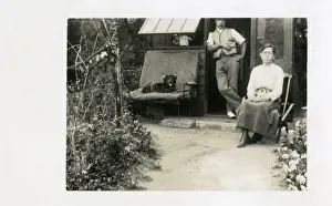 Middle aged couple in back yard with dog