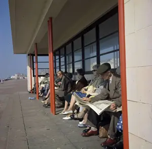 Paved Prints: Middle-aged people in a beach shelter at the seaside