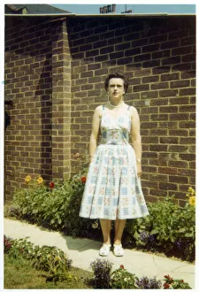 Images Dated 4th February 2021: Middle aged woman on a path in a suburban British garden