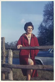 Images Dated 4th February 2021: Middle aged woman posing for photo by a fence