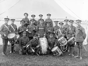 Military band with instruments in front of a tent