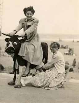 Milking a fake comedy cow at the seaside
