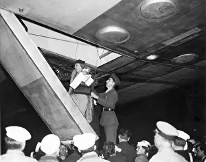 Aboard Prints: Miss Mary Day Winn of New York is helped aboard LZ 129 H?
