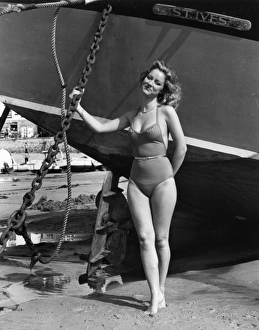 Images Dated 18th November 2016: Model on beach with fishing boat, St Ives, Cornwall