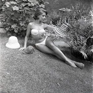 Model sunbathing in a white bikini