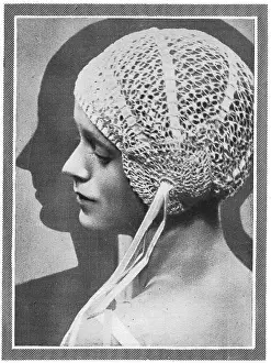 Model wearing close-fitting crocheted bourdoir cap Date: 1929