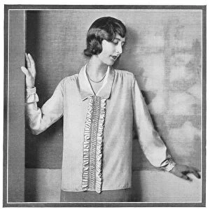 Blouse Collection: A model wearing a loose blouse with a ruffle. Date: 1920s