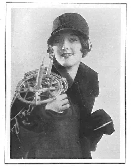 New Images July 2023 Collection: Model wearing a wool hat and holding ski-poles, with one mitten zipped. Date: 1930