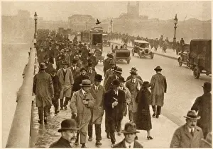 Monday morning rush hour with lots of people walking across London Bridge