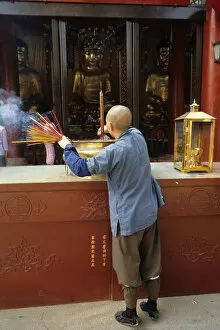Images Dated 8th August 2019: Monk and incense, Temple of the Six Banyan Trees