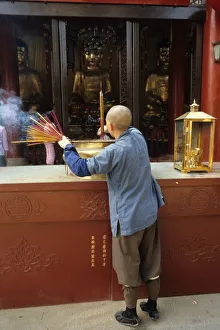 Images Dated 8th August 2019: Monk and incense, Temple of the Six Banyan Trees