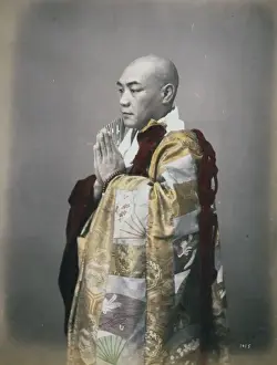 Monk, three-quarter length studio portrait, standing, facing
