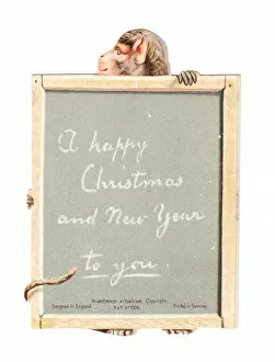 Images Dated 10th December 2015: Monkey holding a slate on a cutout Christmas card