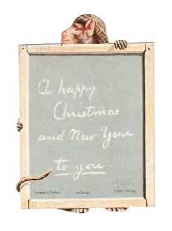 Monkey holding a slate on a cutout Christmas card