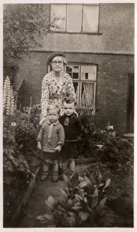 Mother and her two boys in the garden Mother and her two boys in the garden