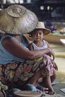 Mother and child wearing traditional Thai hats, or ngobs