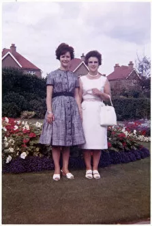 Mother and daughter in pretty suburban back garden