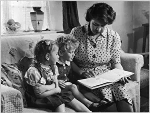 MOTHER READS TO CHILDREN