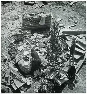 Aftermath Collection: Mother searching for her belongings in debris 1939