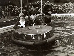 Attraction Prints: Mother and son riding a Rytecraft Scoota-boat - Llandudno