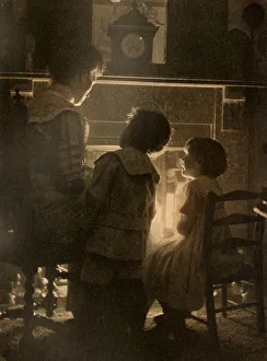 Cosy Prints: A mother tells fairy tales to her children in front of a glowing fire. Date: 1912