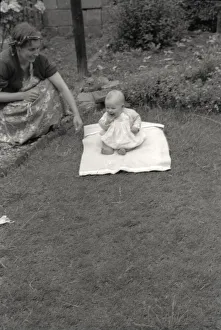 Mother and her young baby playing in the garden
