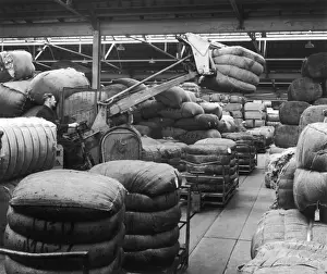 Ware House Prints: Moving large sacks in a warehouse