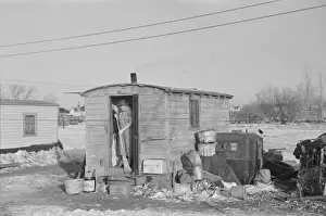 Shack Prints: Mrs. Charles Benning sweeping steps of shack in Shantytown