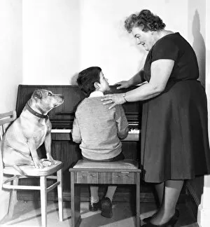 Encouraging Collection: Mrs Mills, celebrity pianist, with boy and dog
